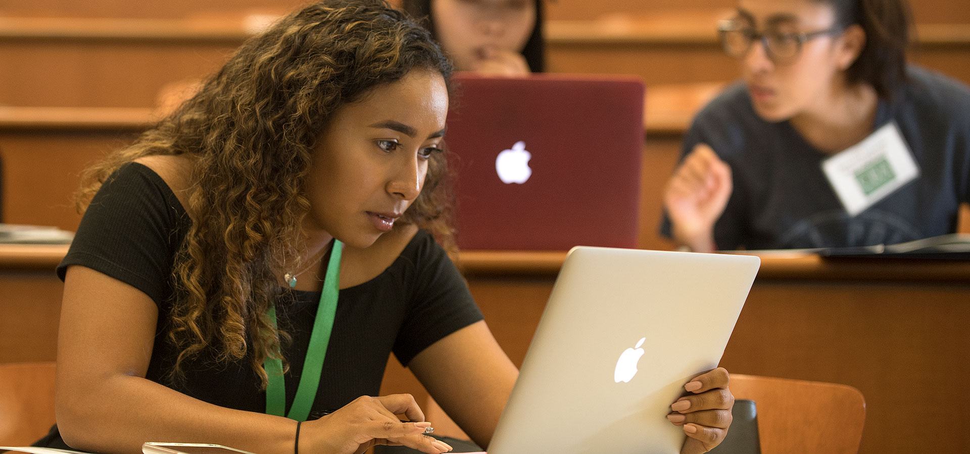 A transfer orientation student works on her laptop. 