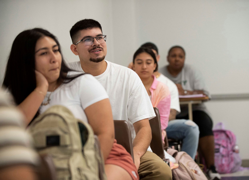 student setting on their desks in a lecture