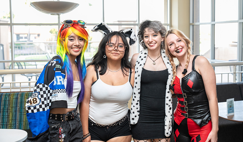 Group of female students in Cosplay pose for a photo during BroncoCon. 
