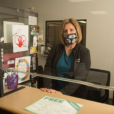 Female Staff member wearing a mask