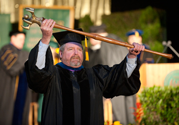 Bob Small carries the mace during commencement