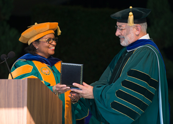 President Coley presents a medal to President Emeritus J. Michael Ortiz