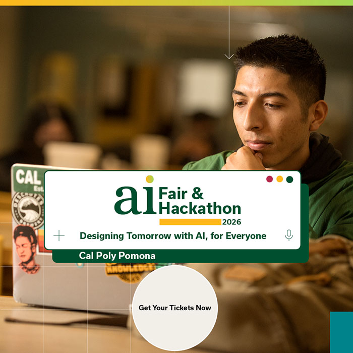 A student sits at a table with a laptop in the University Library