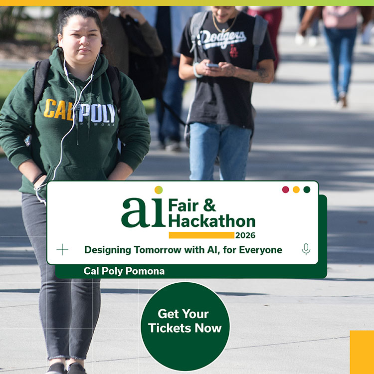 A student walks down a sidewalk on campus with headphones on