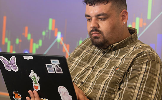 man looking at a laptop