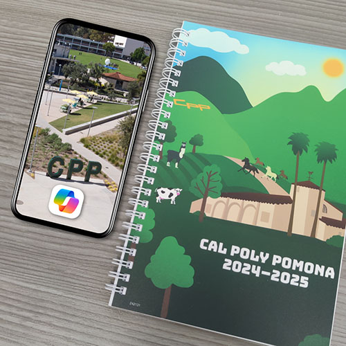 smartphone with a photo of Cal Poly Pomona and the Copilot logo on a desk next to the 2024-25 CPP planner