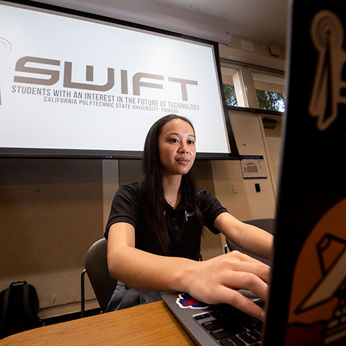 female student working at a laptop