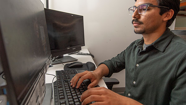 Cal Poly Pomona staff working at a computer