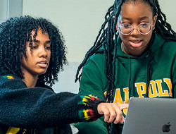 two female Cal Poly Pomona students looking at a laptop