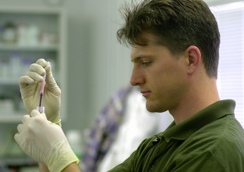 Student holding a vile in a lab