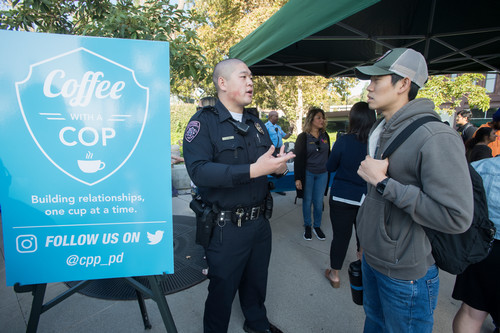 Student conversing with police officer over coffee