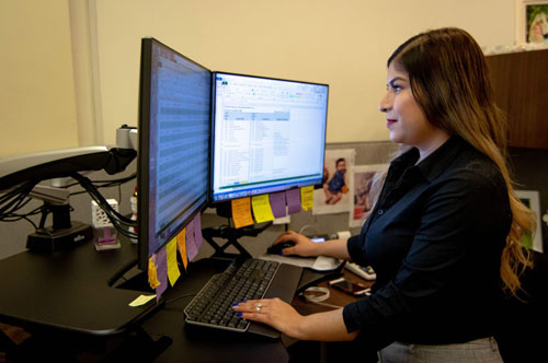 person working in front of computer screen