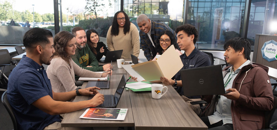 group of faculty and staff meeting at a conference table