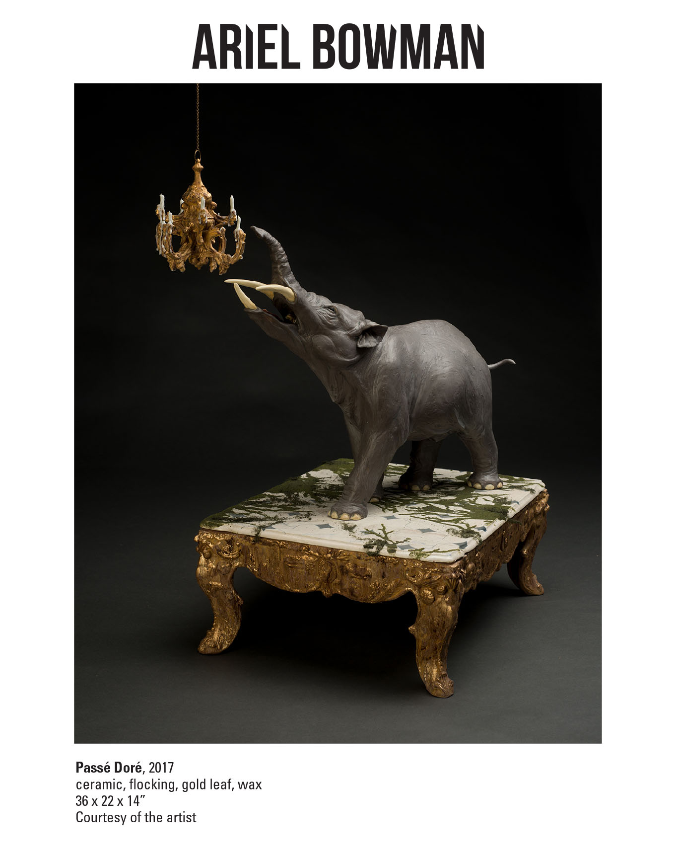 Ariel Bowman, Passe Dore, 2017. Ceramic, flocking, gold leaf, wax. 36 x 22 x 14" Courtesy of the artist. A large elephant like animal with three tusks pointing its head towards a chandelier while standing on a table with gold legs
