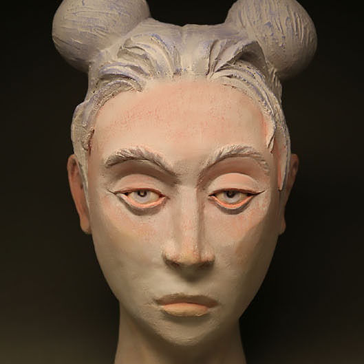 Brian Christensen, Not My Monkeys, Not My Circus, 2018. Ceramic. 22.5 x 13 x 16” Courtesy of the artist. A sculpture of the head of a woman with facial features painted.