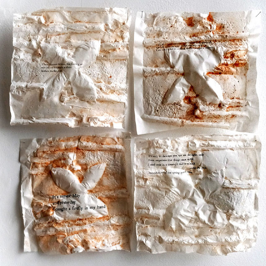 Jennifer Halli, Spring, 2019. Thai kozo, various clays, photographs, pins. 15.5 x 15.5 x 1” Courtesy of the artist. Four clay squares with rough textures covered in a rust color with black text placed on top