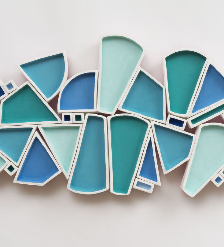 Alexis Kaminsky, Ice Floe, 2019. Ceramic, MDF, casein and spray paint, hardware. 16 x 33 x 2.5” Courtesy of the artist. A sculpture of various triangular and rounded rectangle shapes in blue tonesA sculpture of various triangular and rounded rectangle shapes in blue tones