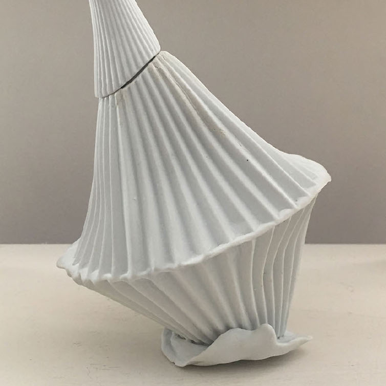 Joy Nagy, Topsy-turvy, 2019. White porcelain vessel. 7.5 x 5 x 5” Courtesy of the artist. A sculpture of a white vessel with vertical lines surround it on all sides