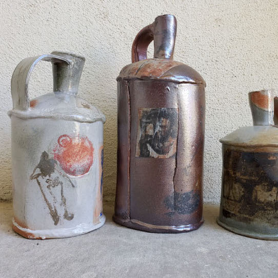 Marie Nagy, Drowning in Memories, 2019. Ceramics. 16 x 22 x 8” Courtesy of the artist. Three different colored cup-like containers with a handle and spout