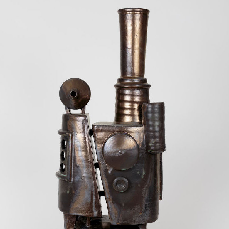 Steven Osterlund, Quod Opus, 2017. Ceramic. 28 x 11 x 12” Courtesy of the artist. A sculpture of industrial looking equipment with various shapes in a bronze color