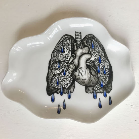 Button to enlarge Sarah Petty, Grief, 2018. Found ceramic plate, china paint. 6 x 5 x 4.5” Courtesy of the artist. A ceramic plate with painted lungs and heart dropping blue drops.
