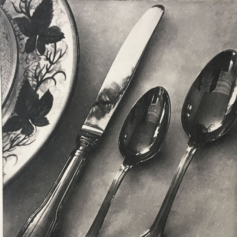 Anita Seltzer, Edith Wharton Tablescape, 2018. Photopolymer intaglio etching, plate Hahnemuhle Copperplate etching paper, Akua Ink, Charles Brand Press. 10.25 x 7.620” Courtesy of the artist. A monochrome etching of silverware. Anita Seltzer, Edith Wharton Tablescape, 2018. Photopolymer intaglio etching, plate Hahnemuhle Copperplate etching paper, Akua Ink, Charles Brand Press. 10.25 x 7.620” Courtesy of the artist