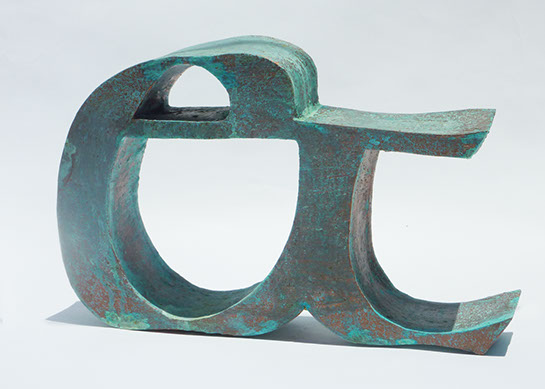 Sculpture of an ampsersand, colors include dark browns and aqua greens