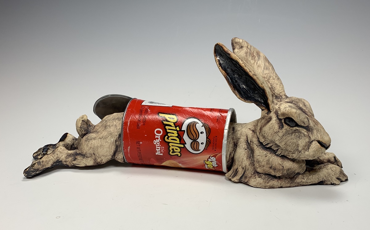 Sculpture of a rabbit caught inside of a pringles canister