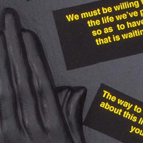 Two hands together in prayer position with black boxes with yellow text surrounding the hands