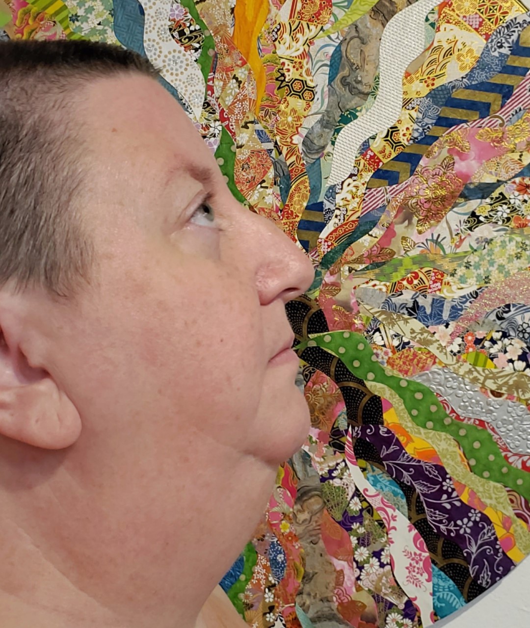 Kristine Schomaker in front of a collage of patterns and textures