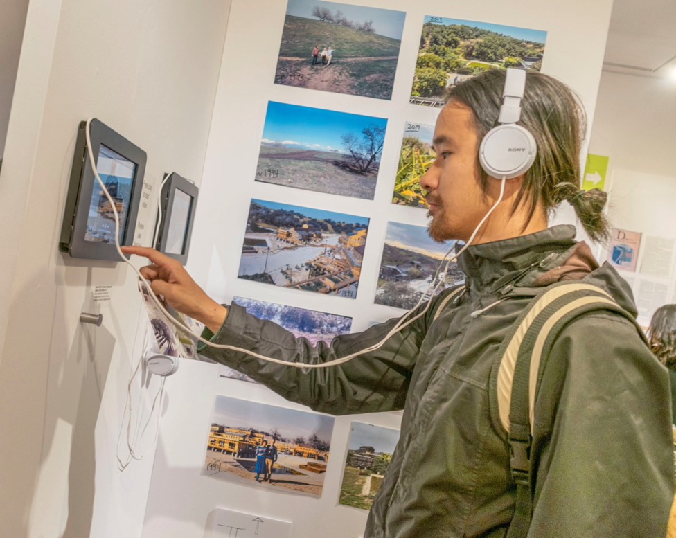 Visitor interacting with video media installation. navigate down for further details