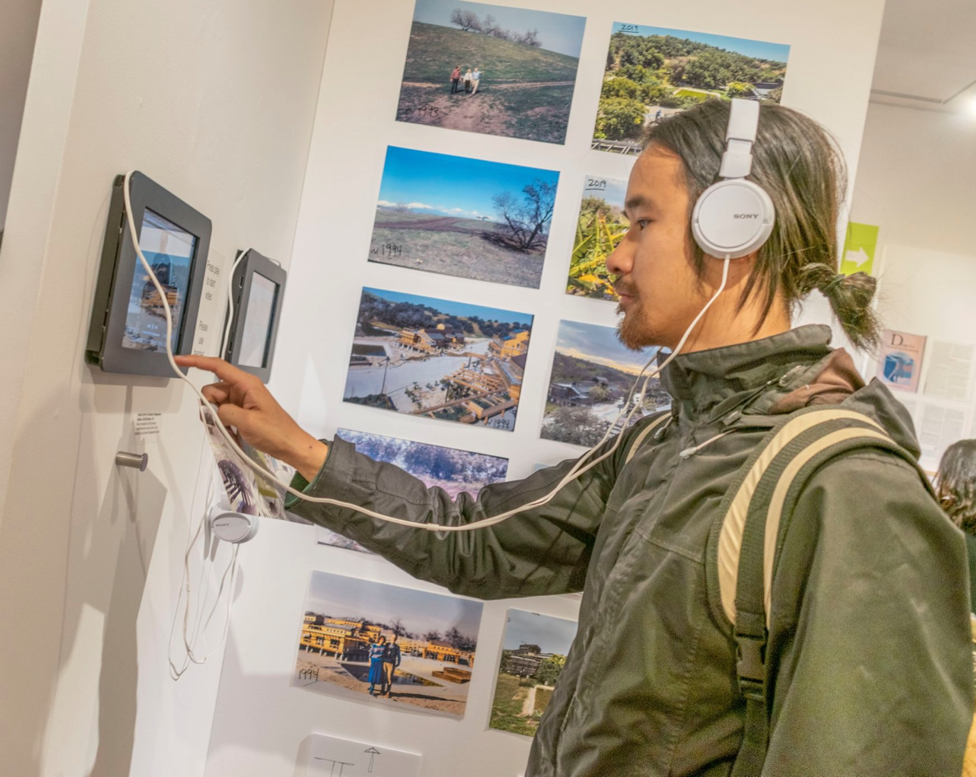 Visitor interacting with video media installation.  navigate down for further details