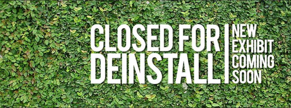 Closed for deinstall graphic with green vine covered brackdrop. New exhibit coming soon