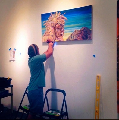 Gallery Student Volunteer assisting in installation. navigate down for further details