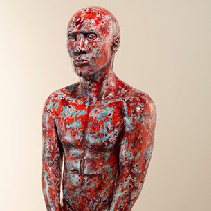 Frank Barron, "Untitled" a sculpted figure painted with paint splotches in red, blue, and various other colors. 
