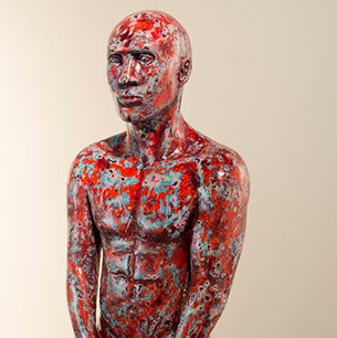 Frank Barron, "Untitled" a sculpted figure painted with paint splotches in red, blue, and various other colors.