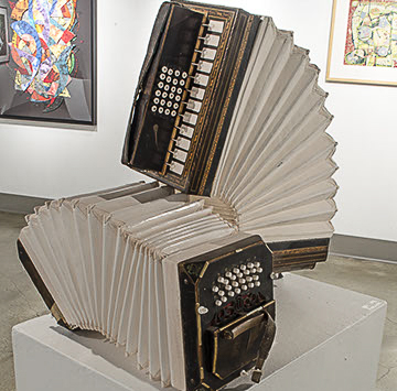 Nate Betschart "1904, 1912, 2012 Accordions" shows two accordions folded on one another.  