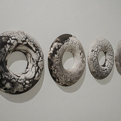 Gale McCall, "Life Saver" four circular sculptures all with a hole through them.