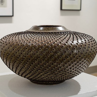 Lee Middleman, "Sunflower - Winter Series"  a wide vase with small black points going all around it.