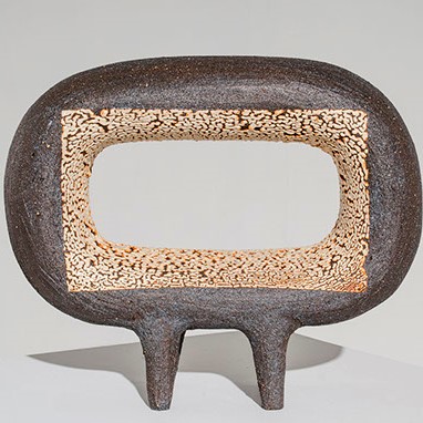Heather Rosenman, "Neon Vision" an abstract brown sculpture with a hole in the middle.