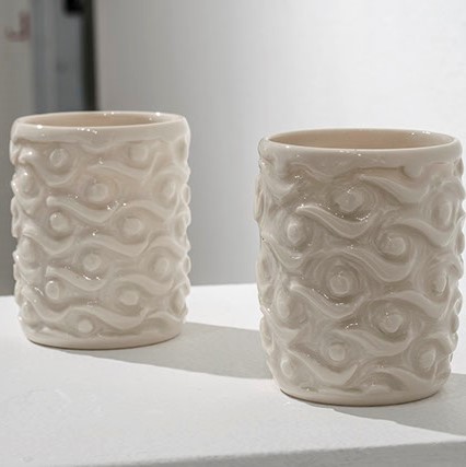 Caitlin Ross, "Moon Over the Water Set" 2 cup like objects, both in a cream color.