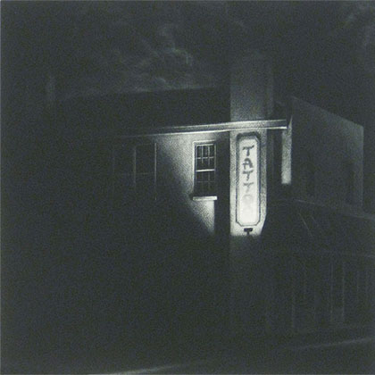 dark corner store with only an indirect lighting towards the tattoo shop sign
