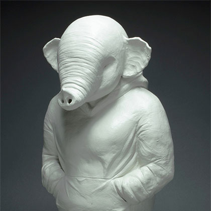 white ceramic sculpture of an elephant in a hoodie standing with its hands in its pockets