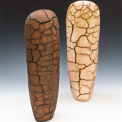 handbuilt earthenware, painted with soluble metal salts; two vertical sculptures (one is darker brown and one is beige/tan) that resembles the cracks on a dirt ground