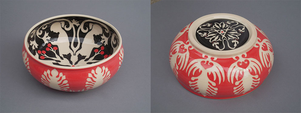 red ceramic bowl with hand-cut white flower patterns and a black interior of a girl on her cell phone