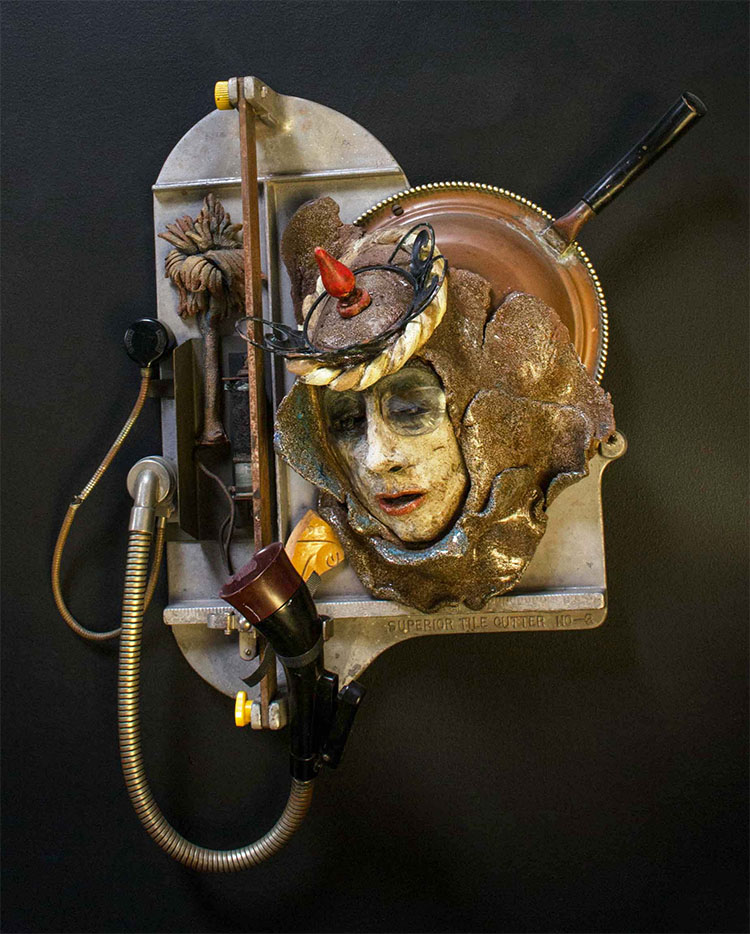 sculpture of a person using an old telephone device; sculpture is made out of assemblage: clay with Ediphone parts, tile cutter and found objects