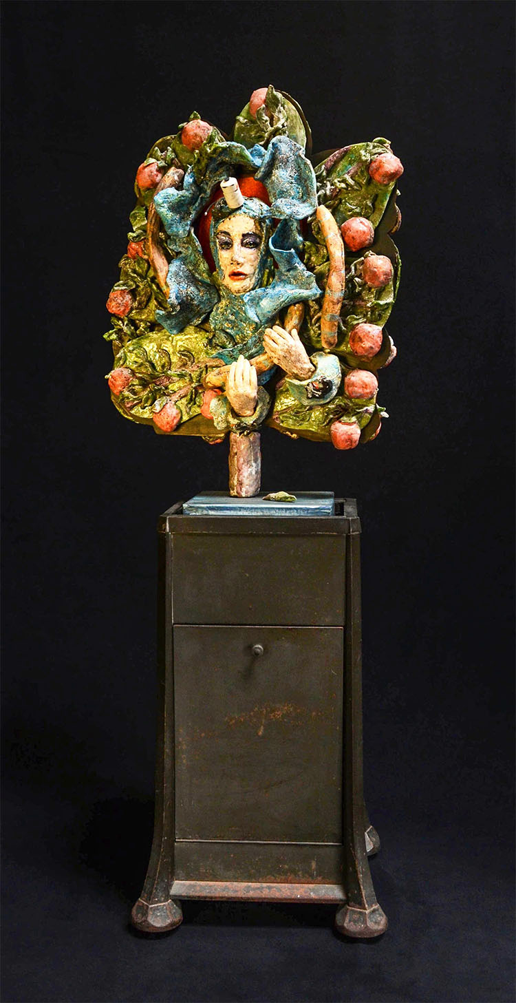 assemblage: clay with Ediphone base, steel and found objects sculpture of a lady surrounded by apples