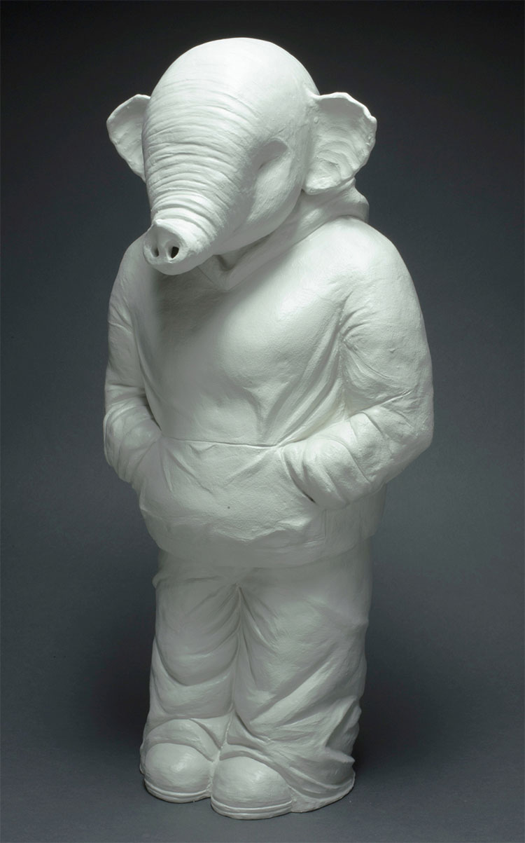 white ceramic sculpture of an elephant in a hoodie standing with its hands in its pockets