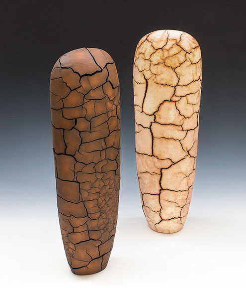 handbuilt earthenware, painted with soluble metal salts; two vertical sculptures (one is darker brown and one is beige/tan) that resembles the cracks on a dirt ground