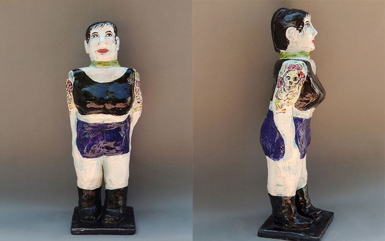 ceramic, hand-built with slabs, low-fire clay and glaze sculpture of a woman with short hair, wearing a black crop top and blue shorts, with tattoos on her arm